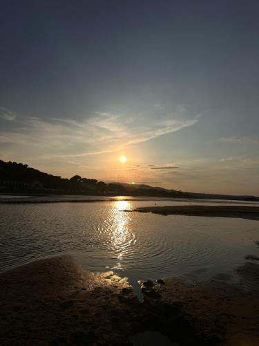 a sunset over a body of water with the sun at Village villa, private pool, canal du midi in Argens Minervois