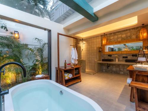 a bathroom with a large tub in a room at Moustache Goa Luxuria in Vagator