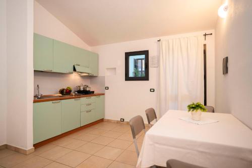 a kitchen and dining room with a table and chairs at Residence Stella Dell'Est in Bari Sardo