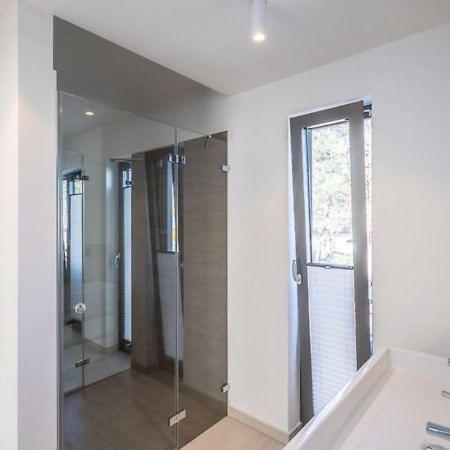 a bathroom with a shower and a large mirror at Meerblick-Residence-Appartement 6 in Breege