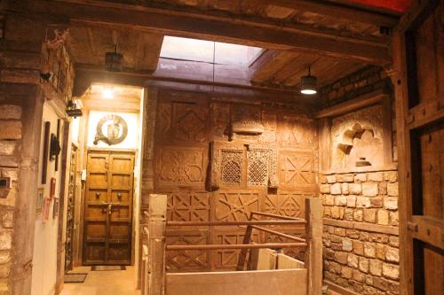 a room withieval wooden walls and a door in a building at Castle View Heritage Haveli in Jodhpur