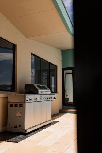 a kitchen with a stove in a house at Heated magnesium pool, MTB, family & dog friendly in St Helens