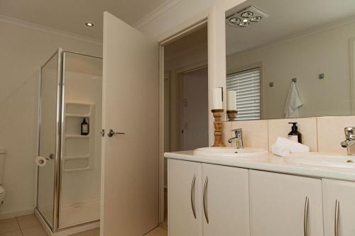 a bathroom with two sinks and a mirror at Heated magnesium pool, MTB, family & dog friendly in St Helens