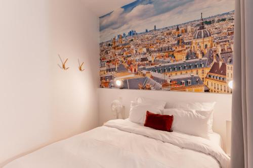 a bedroom with a painting of a city at Saint germain sartre apartment in Paris