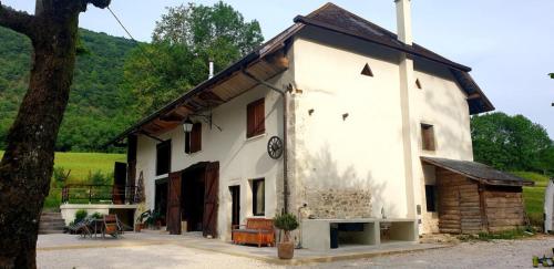 a white house with a brown roof at Maison de campagne 10 min d'Aix in La Biolle