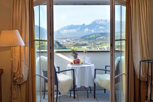a room with a table with a view of a mountain at Hotel Panorama Royal in Bad Häring