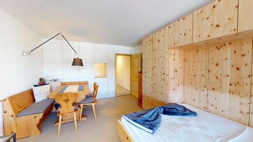une chambre avec un lit, un bureau et une table dans l'établissement Au Réduit 403, à Saint-Moritz