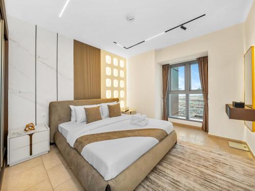 a bedroom with a large bed and a large window at SKY HIGH 2 BHK # Ain Dubai & Sea View # Marina & JBR in Dubai