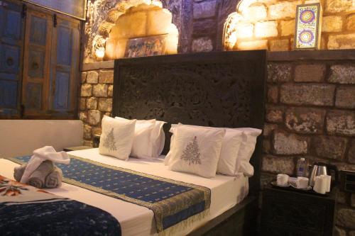 a bedroom with two beds with white pillows at Castle View Heritage Haveli in Jodhpur