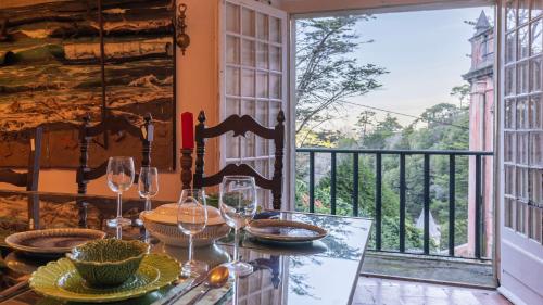a table with wine glasses on top of a balcony at Small Cozy Room in Palace Patio with Hot Tub and Snooker - Sintra WOW in Sintra