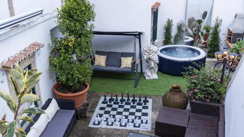 a garden with a chessboard and a bath tub at Small Cozy Room in Palace Patio with Hot Tub and Snooker - Sintra WOW in Sintra