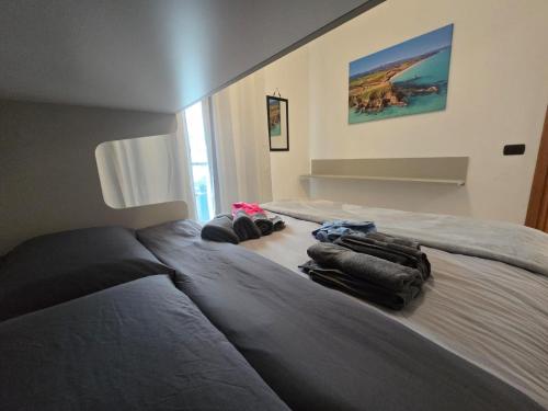 a bedroom with two beds with bags on it at Selida Aquamarine House in Vasto