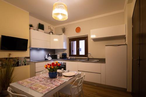 a kitchen with a table and a kitchen with a sink at CADEMU Camaga in LʼAquila