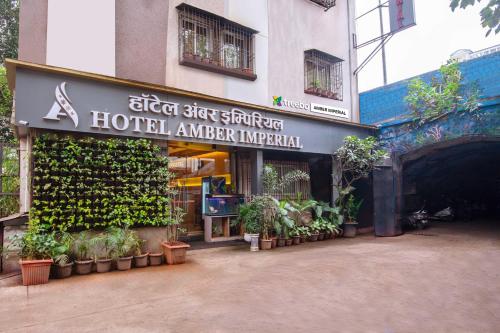 a hotel entrance with plants on the side of a building at Treebo Amber Imperial in Mumbai