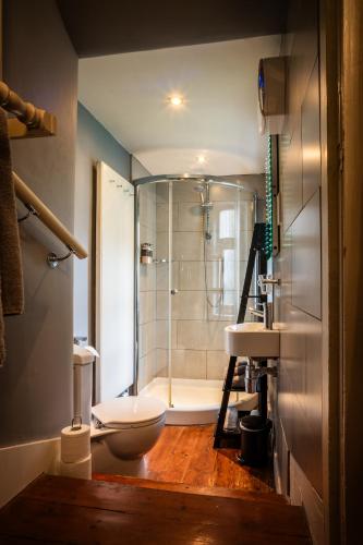 a bathroom with a shower and a toilet and a sink at Six Brunton Place Guest House in Edinburgh