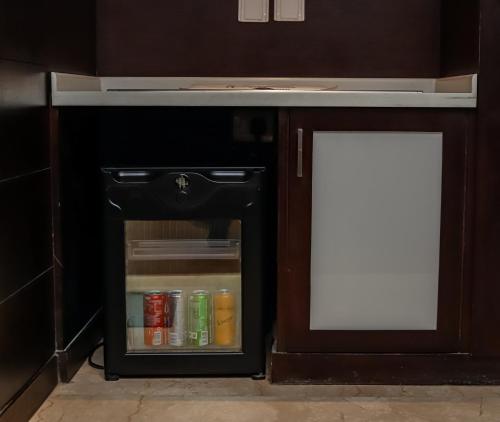 an open refrigerator with a white sign in it at Hotel Godwin Deluxe - Free Airport Pick-Up in New Delhi