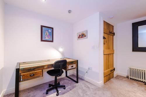a desk with a chair in a room at Belvedere House - Serene Countryside Escape - 4 Bedrooms Sleeps 8 in Wheelock