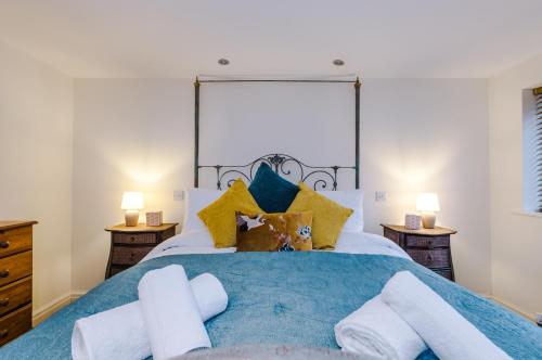 a bedroom with a large bed with towels on it at Belvedere House - Serene Countryside Escape - 4 Bedrooms Sleeps 8 in Wheelock