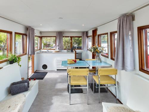 a kitchen and dining room with a table and chairs at Your Houseboat Amsterdam in Amsterdam