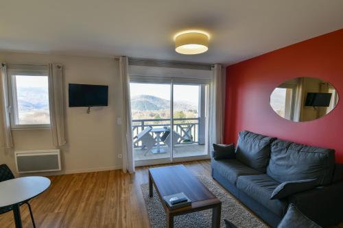 PouzacにあるLe Domaine du Golf Country Club de Bigorreのソファとテーブルのあるリビングルーム