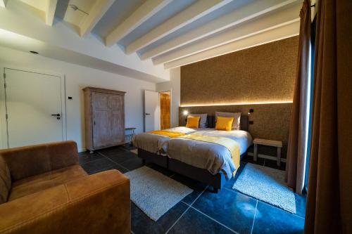 a hotel room with a bed and a couch at Barabois luxury vacation home in Ronse