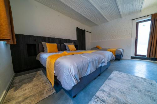 a bedroom with two beds and a window at Barabois luxury vacation home in Ronse