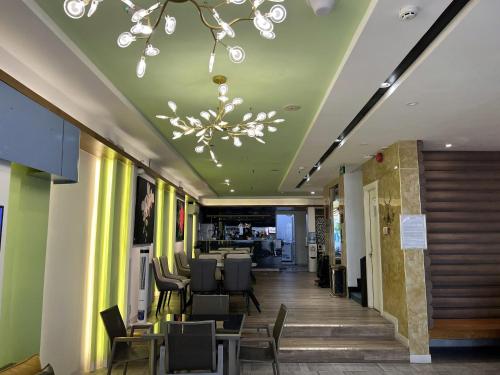 a dining room with chairs and a chandelier at A25 Hotel - 142 Bùi Thị Xuân in Ho Chi Minh City