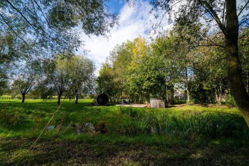 a park with trees and grass and a field at Barabois luxury vacation home in Ronse