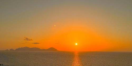 a sunset over the ocean with the sun in the sky at PonzaSmeralda Le Forna in Ponza