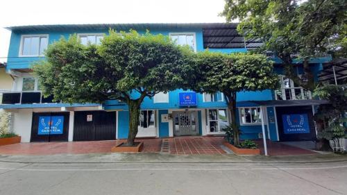 a blue building with trees in front of it at HOTEL Casa Real RIVERA HUILA in Rivera
