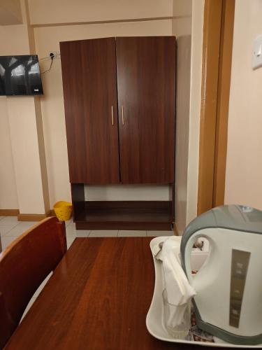 a bathroom with a toilet and a cabinet at Roza Guest House in Naivasha