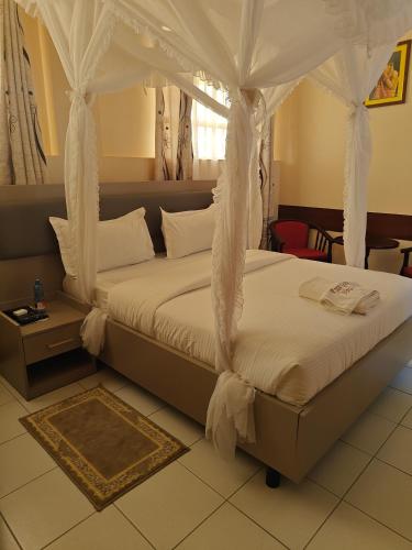 a bedroom with a bed with a canopy at Roza Guest House in Naivasha