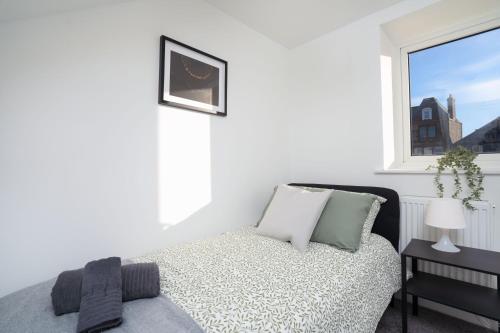 a white bedroom with a bed and a window at Modern 5 BED-2 BATH Apartment in Galashiels