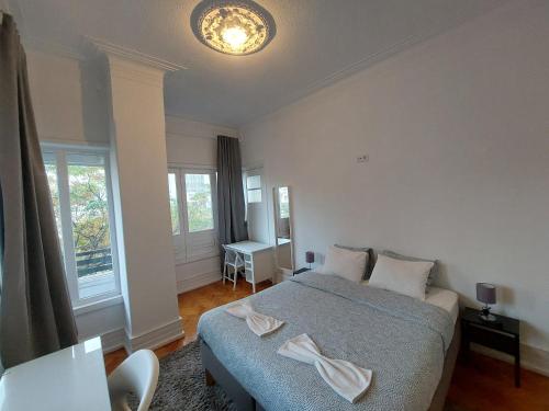 a bedroom with a bed and a desk in it at Don Alvares in Lisbon