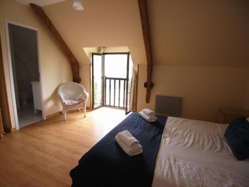 une chambre avec un lit avec deux serviettes dessus dans l'établissement Gîte Fraise - Les Gîtes de la Lohuas, à Les Champs-Géraux