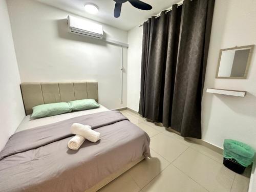 a bedroom with a bed with two towels on it at Elegent Stay Rawang by Bliss Stay Management in Rawang