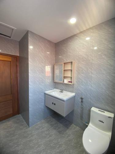 a bathroom with a toilet and a sink at Jasminsorium in Phnom Penh