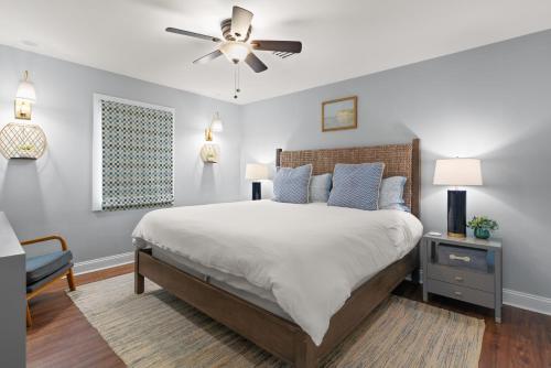 a bedroom with a bed and a ceiling fan at Tranquility - 4318 Tenth Street in Saint Simons Island