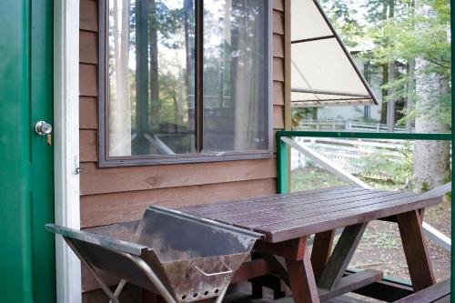 a picnic table on the porch of a house at PICA Fujiyoshida in Fujiyoshida