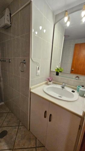a bathroom with a sink and a mirror and a shower at Almuñécar Velilla Sea View in Almuñécar