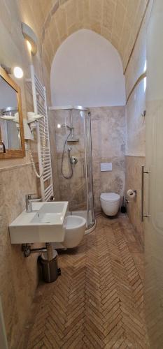 a bathroom with a sink and a shower and a toilet at Due forni affittacamere in Matera
