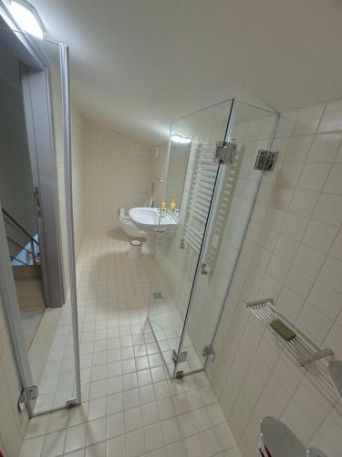 a bathroom with a shower and a sink and a toilet at Maisonette Mountain View - Euphoria Resort in Borovets