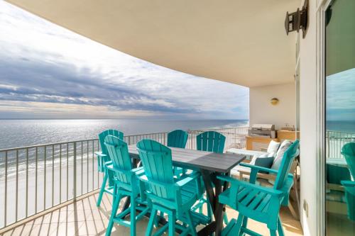 a balcony with a table and chairs and the ocean at Turquoise Place Condos in Orange Beach