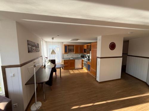 a kitchen and living room with a table and a refrigerator at Hotel Schöne Aussicht in Bad Friedrichshall