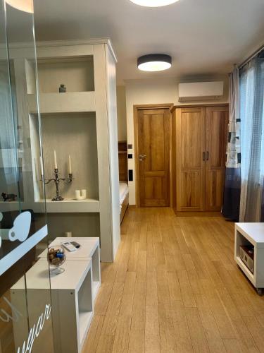 a living room with a room with a desk and a door at V A z A T A apartment in Ruse