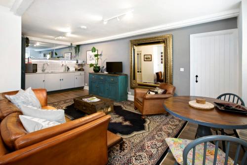 a living room with a couch and a table at Woodville Barn in Dunster