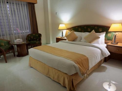 a hotel room with a large bed and a window at HOTEL LAKE CASTLE - Parkview in Dhaka