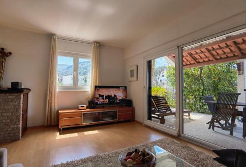 a living room with a tv and a sliding glass door at Jees Exclusive Apartments Hvar in Stari Grad