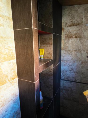 a shower with a wooden shelf in a bathroom at Kimon Penthouse in Thessaloniki