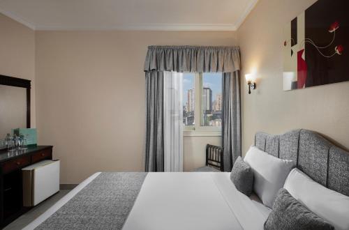 a hotel room with a bed and a window at Holidays Express Hotel in Cairo